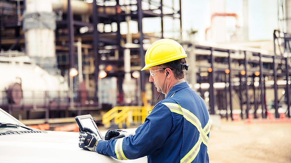 Worker checking data on a tablet while at the construction site
